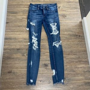 American Eagle mid waist skinny ripped jeans with rips in the back